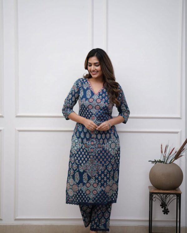 Woman wearing a stylish navy blue Pure Cotton Suit with traditional block prints, featuring a Kurti and matching pant set with side pockets – fully stitched ethnic outfit.