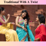 Three women in colorful sarees enjoying a joyful moment on traditional red stone steps, representing elegant ethnic fashion with a modern twist—perfect for promoting a Clothing Store for Sale offering vibrant traditional wear.