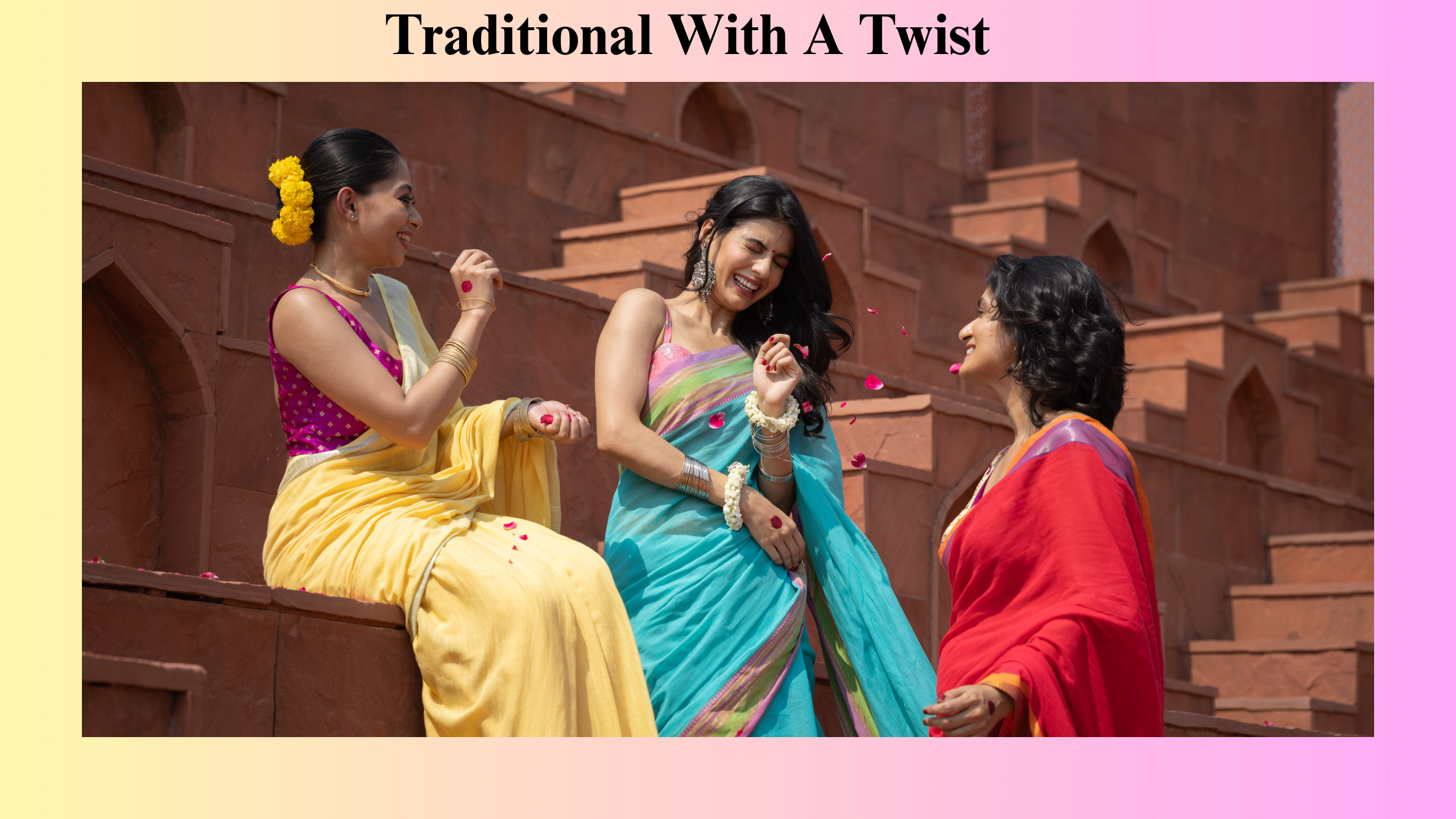 Three women in colorful sarees enjoying a joyful moment on traditional red stone steps, representing elegant ethnic fashion with a modern twist—perfect for promoting a Clothing Store for Sale offering vibrant traditional wear.