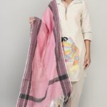 Woman wearing off-white embroidered cotton kurti with hand block print, holding a pink handwoven dupatta