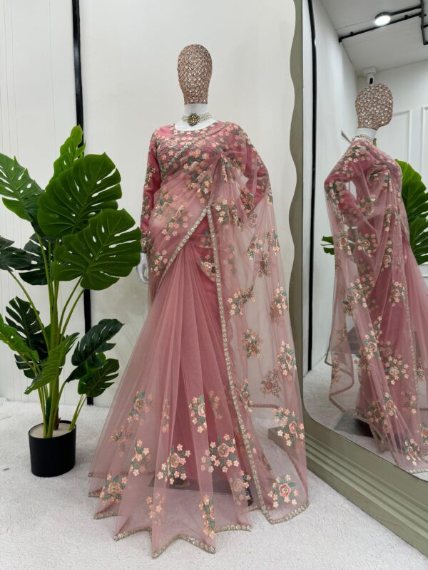 Woman wearing soft net designer saree with thread and sequence embroidery