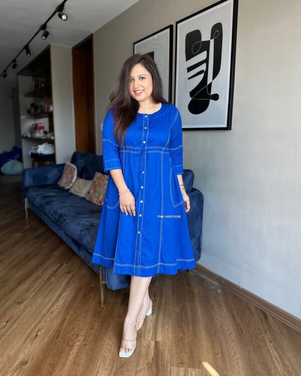 Woman dressed in a royal blue cotton slub short dress with contrast stitch detailing